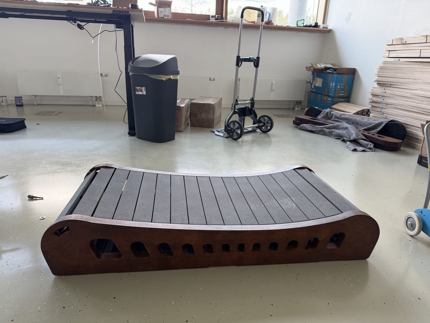Close-up of the Office Walker's wooden slats and steel axle